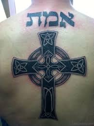 The tattoo depicts a cross tattoo that has been drawn in fancy flowery patterns. 97 Stunning Cross Tattoos For Back