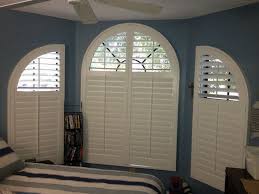 Quality shutters for your style & budget. Curved Windows Can Be Covered With Custom Shutters To Fill The Entire Opening As Pictured Here Or Typica Curtains With Blinds Living Room Blinds House Blinds