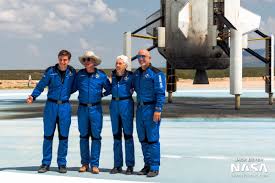 Bezos, wearing a blue flight suit and cowboy hat, and the other passengers climbed into an suv vehicle for a short drive to the launch pad before walking up a it represents blue origin's first crewed flight to space. Ewepkerqdq V6m