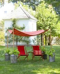 Finding fabric for the outdoor canopy was much easier! Good Housekeeping Outdoor Canopy Made With Old Milk Jug Cans I D Never Find The Cans Or Be Willing To Pay Lots For T Canopy Outdoor Diy Canopy Garden Canopy