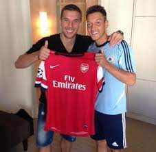Mesut ozil and lukas podolski holding arsenal shirt. Photo Mesut Ozil And Lukas Podolski Holding Arsenal Shirt Sportslens Com