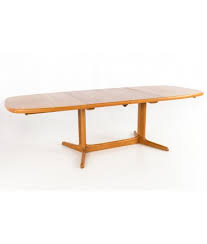 With its clean lines and understated look, this set uses new materials to reimagine a traditional design. Rasmus Mid Century Modern Danish Teak Expanding Hidden Leaf Dining Table