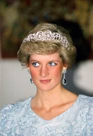 Diana, Princess of Wales, wearing a pale blue dress with polka dots...