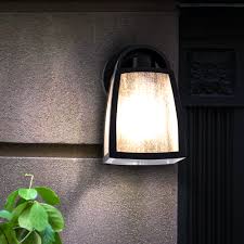 Painted in rich deep black, the wall light offers illuminating ambiance and appearance to any given outdoor area. Outdoor Wall Sconce Alu Glass Black Kelsey Meinelampe