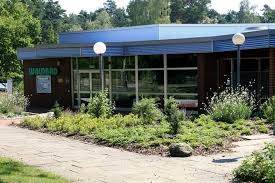 4k00.25close up of an young woman is enjoying and having relax in an indoor illuminated with night lights swimming pool in a luxury wellness center. Hermannsburg Waldbad Indoor Swimming Pool