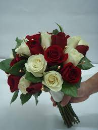 A small, beautiful bouquet of pink roses is decorated with greenery. Red And White Roses Wedding Bouquets Flower Bouquet Wedding Red Bridal Bouquet