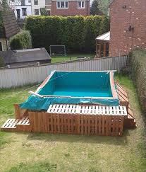 Securing The Stetched Pool Cloth Tarp Edges Pallet Pool Building A Swimming Pool Diy Swimming Pool
