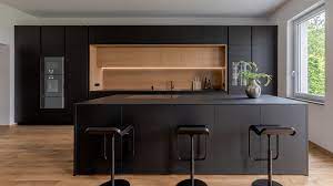 Keep your flooring lighter as a contrast if you have black cabinets, and pick a pattern that also has black or some grey tones to create a cohesive look. Eye Catching Black Kitchens Bora Kitchen Design Bora