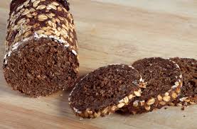 A hollowed loaf of pumpernickel is filled with a simple spinach dip. What Does Pumpernickel Bread Taste Like Thrive Cuisine
