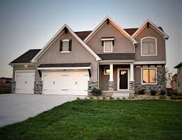 White works beautifully with any other colors, making them pop out even more. Beautiful 2 Story Home Grey And White Exterior Grey Stone Exterior Black Front Door Luxury Houses Mansions New Home Builders Home Builders