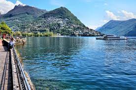 Straddling the border between switzerland and italy, lake lugano offers the best of both countries. Beauty Of Lake Lugano And Alpine Mountains In Lugano Switzerland Encircle Photos