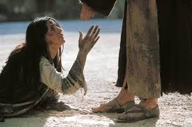 Monica Bellucci as Mary Magdalene, kneeling before Christ in ...
