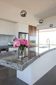 Maybe you would like to learn more about one of these? Modern Kitchen With Curved Island Bench And Chrome Pendant Lights By Rowena Naylor