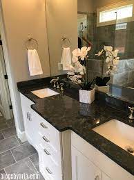 The countertops pop off white wainscoting while still staying in sync with other bathroom surfaces. Parade Of Homes Series Madison Park House Tour Granite Bathroom Countertops Granite Bathroom Dark Granite