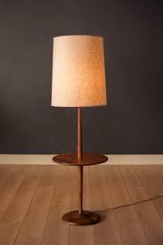 This type of lamp is an excellent option when you don't have much room and would like a for example, some might have a decorative column while others feature a single, plain pole that attaches to a basic lampshade at the top of the lamp. Mid Century Walnut Laurel Floor Lamp With End Table For Sale At 1stdibs
