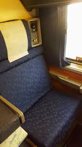 A sofa and armchair by day. Amtrak Superliner Roomette Vs Family Bedroom Travels With Eli