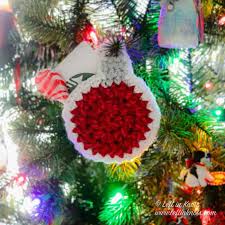 With the gift card inside, use a hole punch to cut a small hole in the top of the gift card holder. Crochet Holly Jolly Christmas Ornament Gift Card Holder Free Pattern Left In Knots