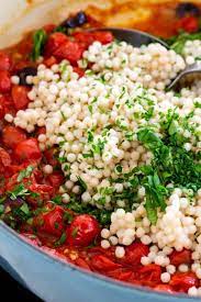 Tossed with colorful vegetables, feta cheese, olives, and garbanzo beans. Israeli Couscous With Tomato And Olives Jessica Gavin