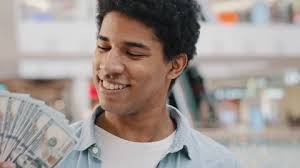 Motivated happy inspired african american guy bank customer rich man  holding fan