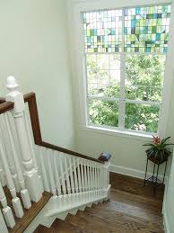 Contemporary winding staircase with dark stained stair treads is illuminated by a smoke gray glass tiered chandelier placed in front of. Houzz Tour A New Home Honors A Historic Neighborhood Traditional Staircase New Homes House Design