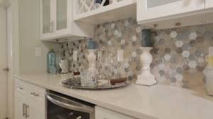 Kitchen peninsula with waterfall counter and glass cabinets. Explore The Wonders Of Mosaic Shapes With Kate Tile Outlets Of America