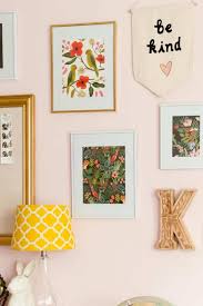 Pink living room with striped walls and a huge tufted ottoman accented with a brown throw blanket in the middle that serves as a center table and an extended sofa at fabulous living room with rose gold accents. How To Decorate A Room Beautifully With Blush Pink Shabbyfufu Com