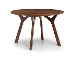 Splayed legs form a unique sculptural base, creating a chic profile from any angle. Julian Bowen Huxley Walnut Round Dining Table From The Bed Station