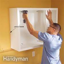 Patch and smooth holes with a putty knife and spackle. How To Install Kitchen Cabinets Diy Family Handyman