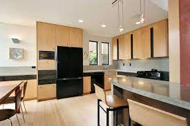 Dark wood cabinets with black appliances. Black Kitchen Appliances Dark And Bold Additions For Every Kitchen