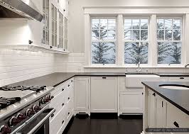 The countertops' fresh whiteness is played up by adding glass backsplash tiles in white. 50 Black Countertop Backsplash Ideas Tile Designs Tips Advice Trendy Kitchen Tile Trendy Kitchen Backsplash White Cabinets Black Countertops