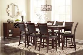 Whether your family gathers around the dinner table every night or twice a year at thanksgiving and christmas, you know your home wouldn't be complete without a dining room table. D564 32 124 9pc 9 Pc Collenburg Dark Brown Finish Wood Rectangular Counter Height Dining Table