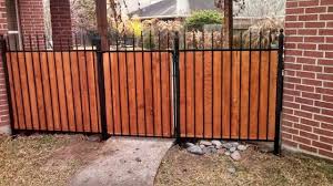 Really Cool Wrought Iron And Cedar Privacy Fence From Houston Quality Fenicng Http Www Woodlandsfence Com Iron Fence Fence Design Wood Privacy Fence