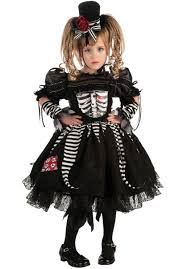 Happy child wearing skeleton costume on halloween leaning on huge pumpkin jack o lantern outdoors. Skeleton Tutu Costume Child Girls Skeleton Costume Toddler Halloween Costumes Girl Costumes