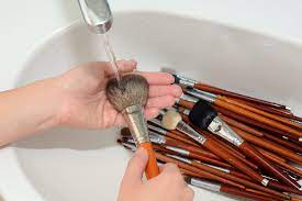 1 removing excess paint from the brush. How To Clean Your Makeup Brushes And How Often You Should Do It Allure