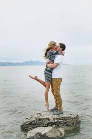 Engaged Couple Shot On Rock By Water Beach Photos Great Pose Passionate Cute Engagement Photos Engagement Photoshoot Engagement Photos