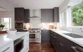 A light color mosaic backsplash tile provides plenty of visual interest and contrast as a backdrop for gray kitchen cabinets. Dark Gray Shaker Kitchen Cabinets Transitional Kitchen