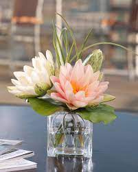 Lia griffith's arrangement keeps interest by adding various heights of florals to the grouping. Lotus Blossom Lily Pad Silk Flower Arrangement Artificial Flower Arrangements Flower Arrangements Artificial Flowers