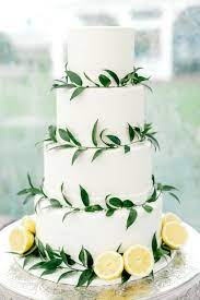 This Minimal White Wedding Cake With Lemon Accents Is So Simple And Elegant That We Re Swooni Romantic Wedding Cake Floral Wedding Cakes Italian Wedding Themes