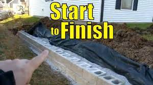 Cinder block garden is an inexpensive solution. Building A Retaining Wall With Concrete Blocks Youtube