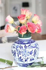 This delicate arrangement includes pink alstroemeria, pink carnations, white miniature carnations, dusty miller, huckleberry, leatherleaf fern, and lemon leaf. Diy Ginger Jar Rose Centerpiece Kinsey Walsh Rose Centerpieces Flower Arrangements Diy Pink Centerpieces