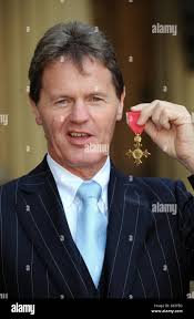 Managing Director of M-Sport and Team Director of Ford World Rally Team Malcolm  Wilson, from Cockermouth poses with his OBE following the investiture  ceremony at Buckingham Palace, London Stock Photo