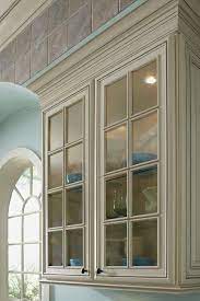 Classic white kitchen with mullion glass doors and cove crown molding. Traditional Mullion Cabinet Doors Schrock Cabinetry Cabinet Doors Mullion Cabinet Doors Glass Cabinet Doors
