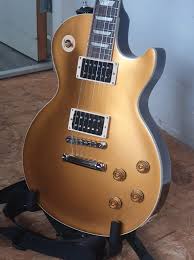 The Slash "Victoria" Les Paul™ Standard Goldtop features a maple top, a  solid mahogany body with a dark finish