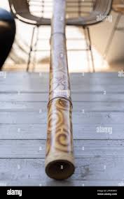 Didgeridoo Decorated With Abstract Design Pattern On Grey Table Traditional Australian Music Instrument Made Of Wood Stock Photo Alamy