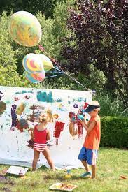 Outdoor Painting Party With Spray Bottles Paint Brushes And A Big Mess Messy Art Kids Holiday Art Messy Party