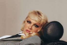 Pamela Anderson bends over to play sexy secretary in suit without trousers