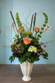 Mixed Flower Arrangement With Roses Bells Of Ireland Hydrangea Orchids And Protea Flower Arrangements Orchids Flowers
