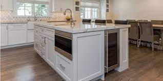 It's surrounded by gray toned cabinets and ample storage space. Design The Perfect Kitchen Island Kitchen Cabinets And Granite Countertops Pompano Beach Fl