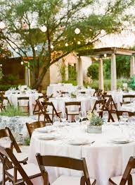 Simple White Linens And Wooden Folding Chairs Help To Capture The Feel Of A Rustic Wedding Situate Twin Wedding Chairs Wedding Reception Chairs Rustic Wedding