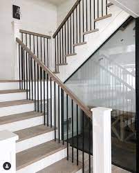 We are trimming out our builder grade kitchen island. Stair Ideas White Front With Light Wood Top And Straight Black Pole Railing Soussoladolescent House Staircase Interior Stair Railing Modern Stairs
